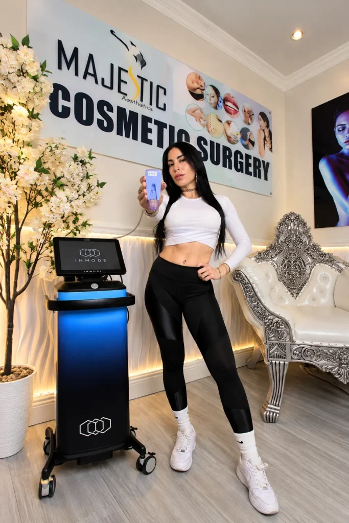 IV Drips: Hype or Help? An Honest Read of 2026's Headlines 2 A member of the care team standing beside a treatment device in front of the Majestic Aesthetics sign